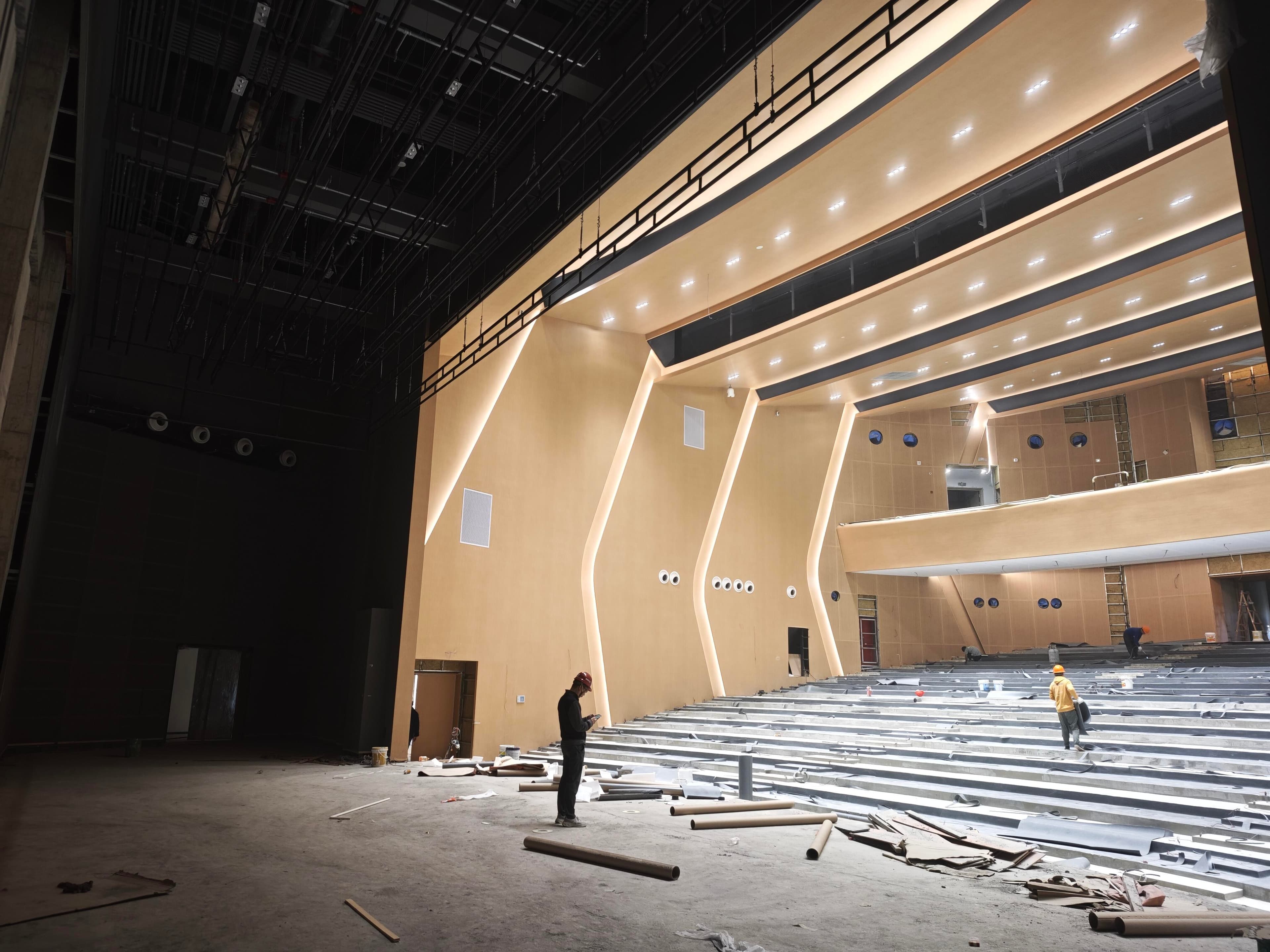 Auditorium construction phase from the stage side with proscenium structure and seating base