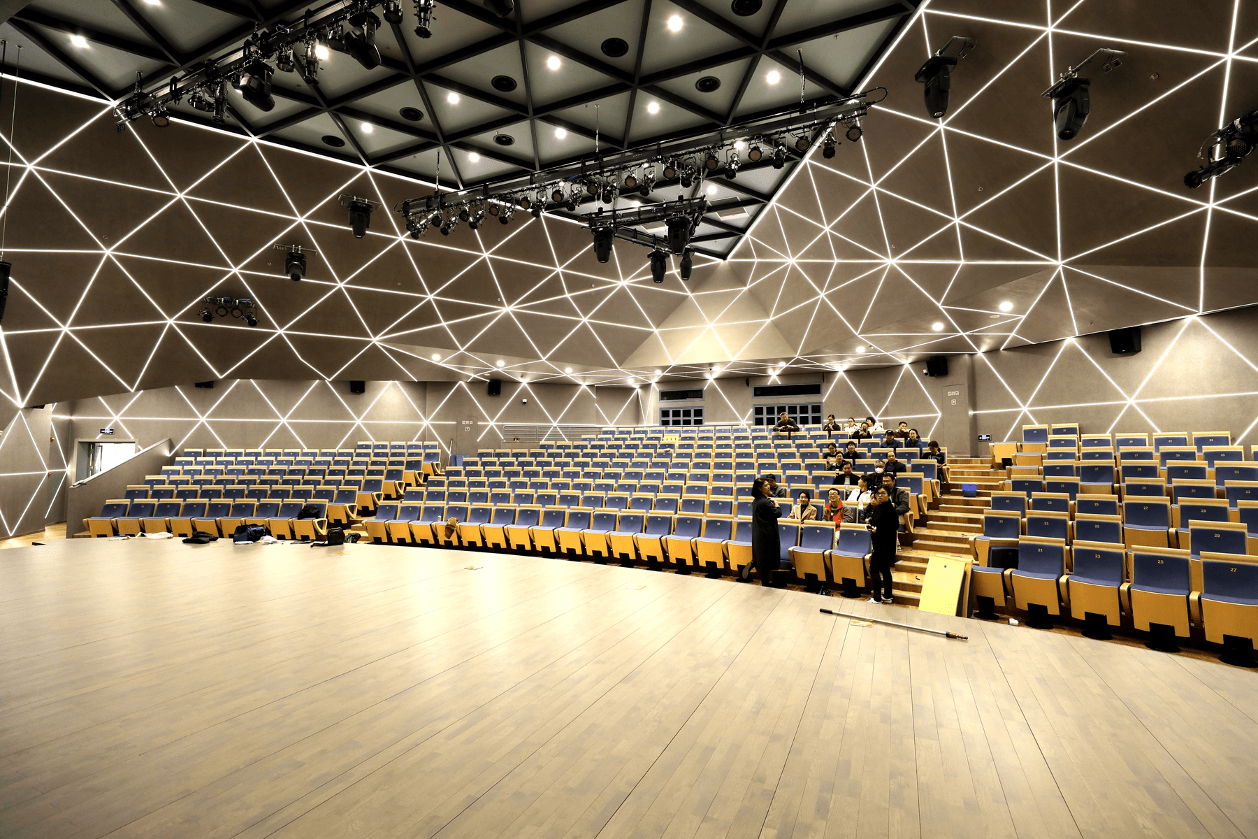 Post-renovation view of the audience seating and geometric walls in the University Multipurpose Hall