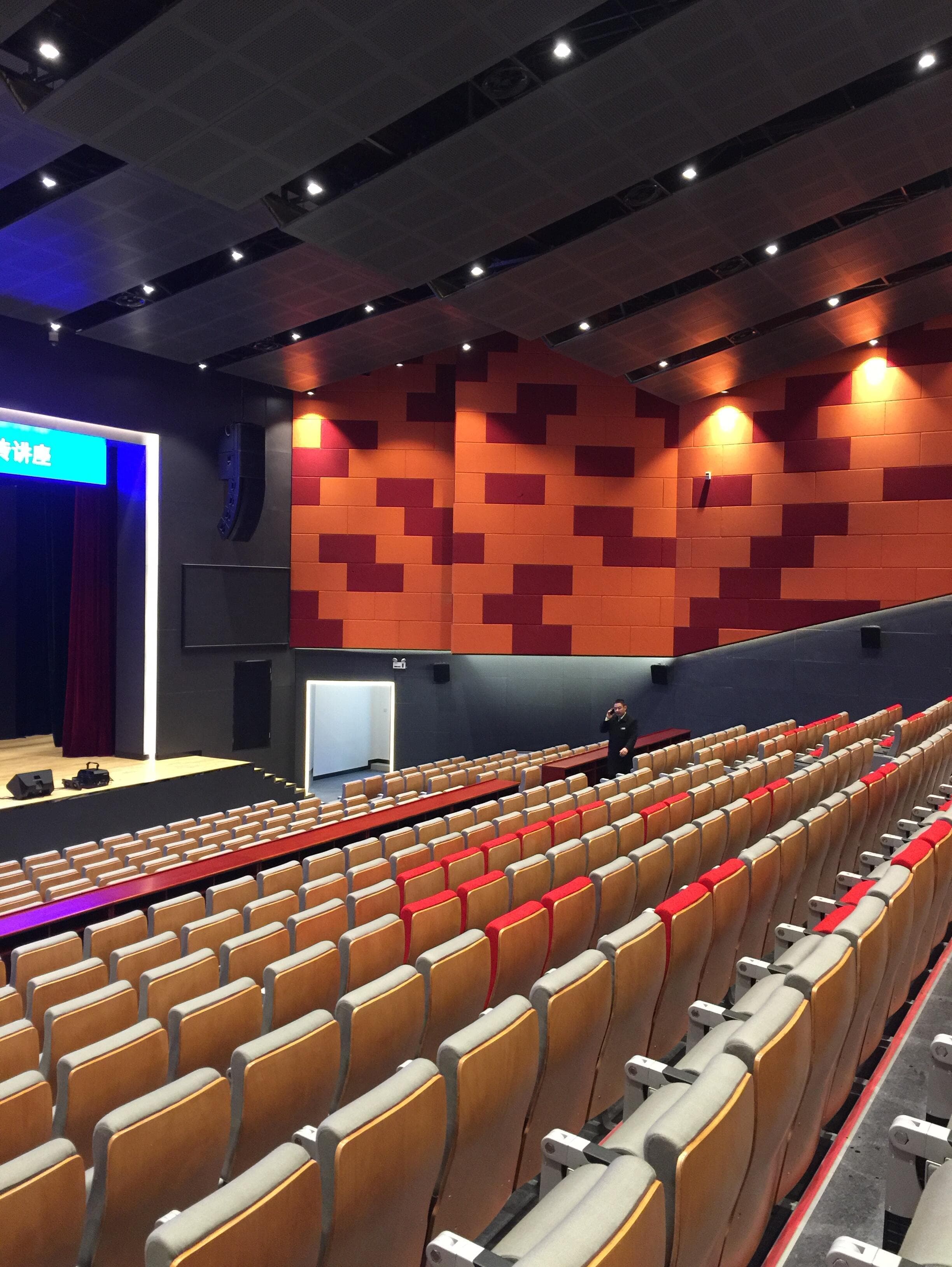Completed proscenium-side wall with flown line-array loudspeaker and acoustic panel field