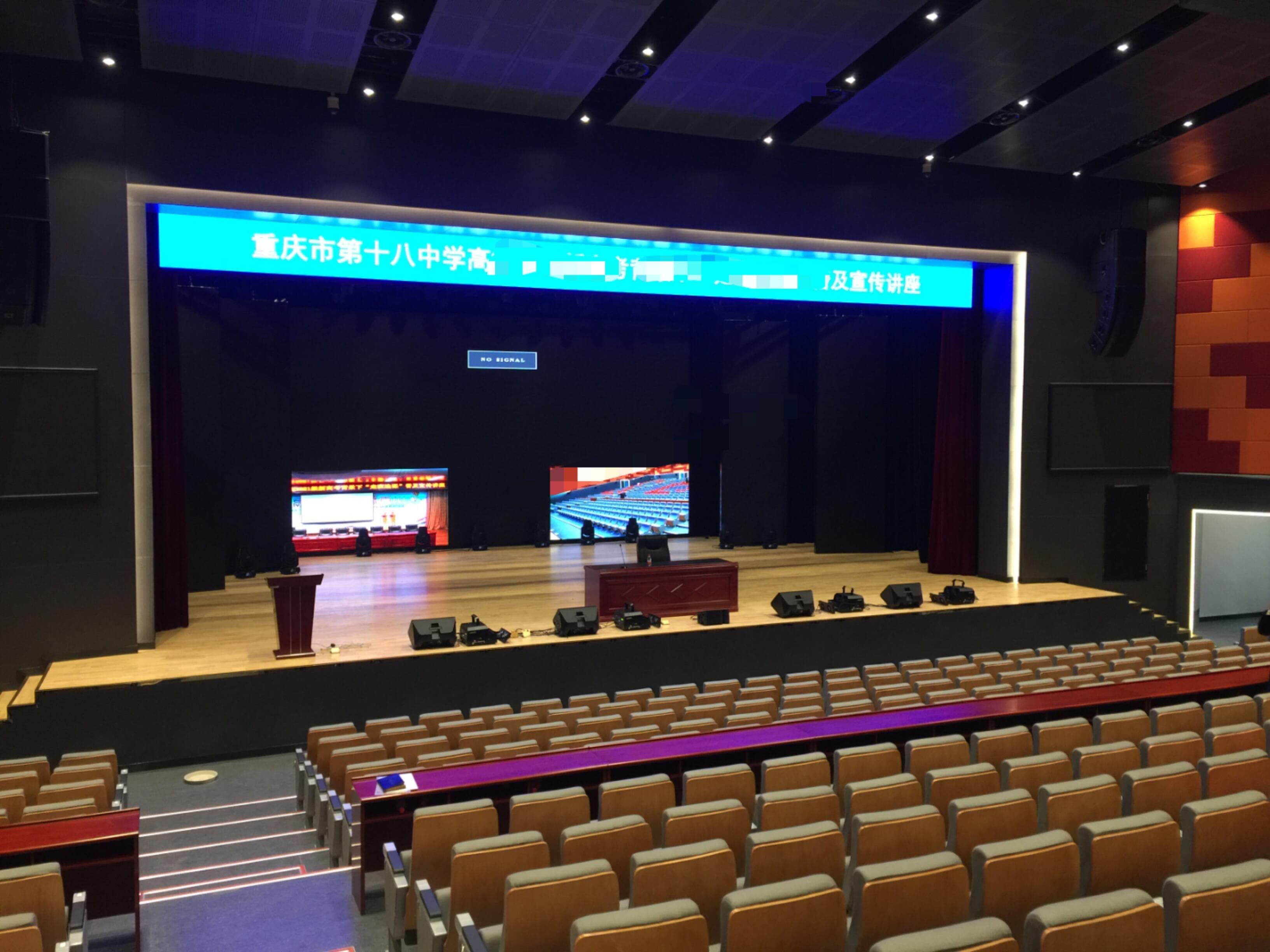 Completed stage-front AVL installation with LED banner, dual rear screens, and monitor speakers