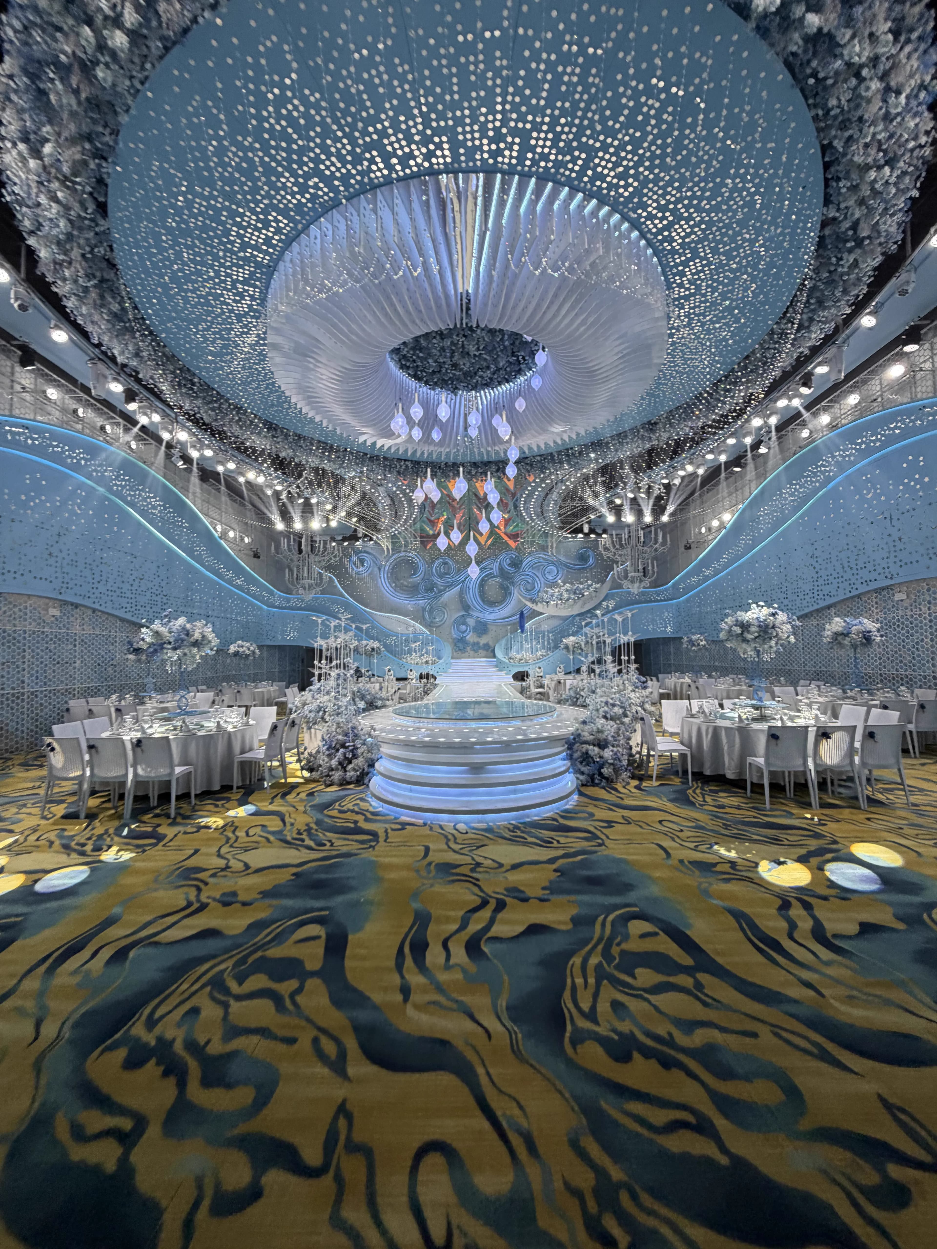 Ocean themed ballroom with panoramic starry sky ceiling and blue stage environment