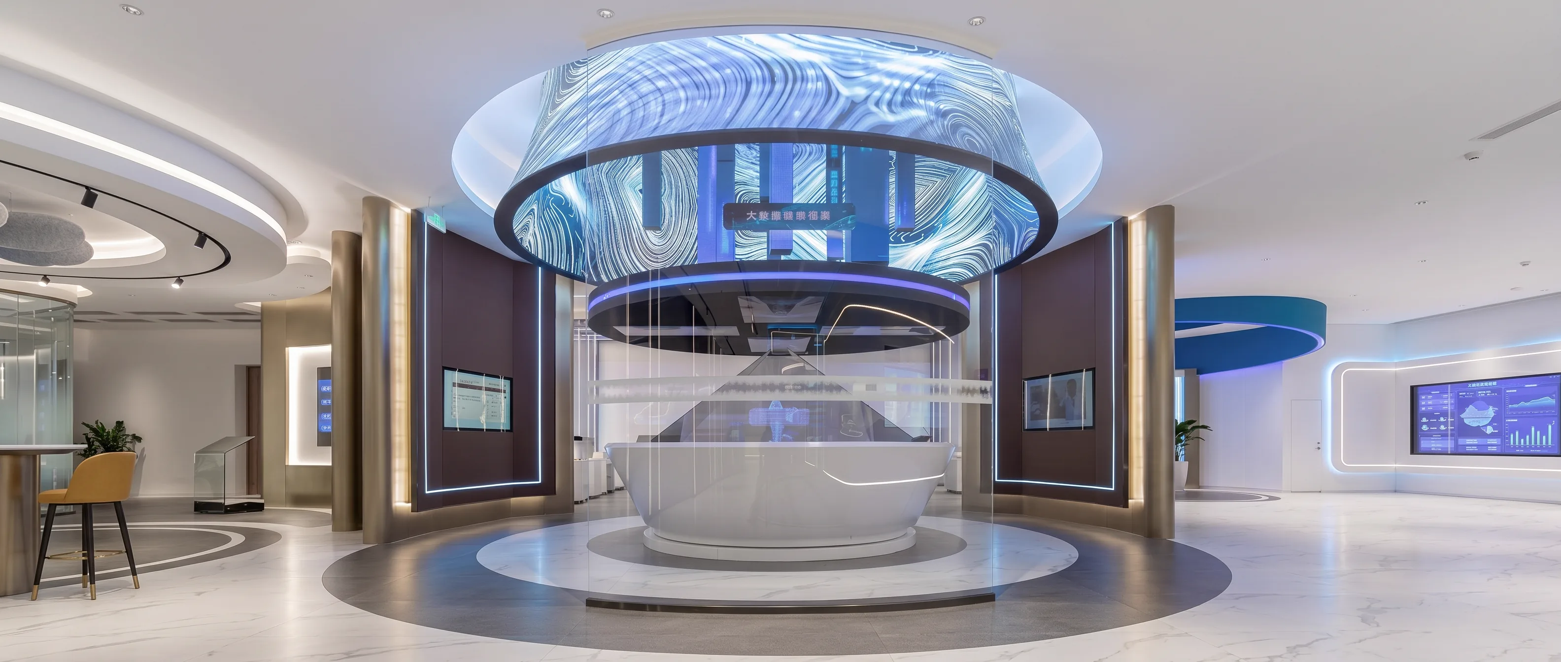Central hub area with suspended circular irregular curved LED array and semi-transparent holographic stage